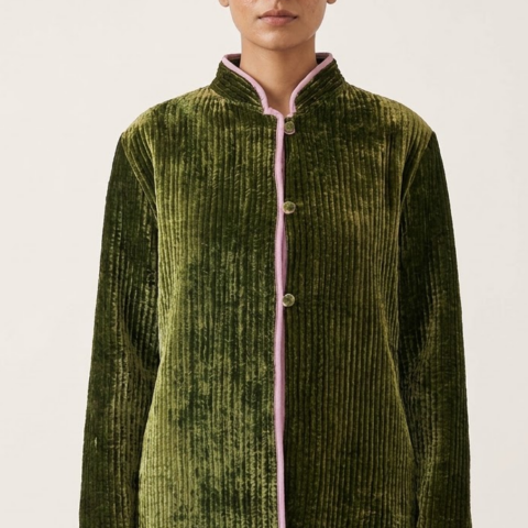 Women’s silk velvet quilted jacket with open sleeves, contrasting pink piping, stand collar, and button-front closure.